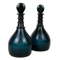 A pair of George III style unusually coloured triple ring neck decanters and stoppers.