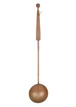 A Middle Eastern copper ladle, early 20th century.