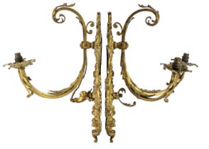 A pair of gilt metal twin branch wall appliques in the Rococo manner.