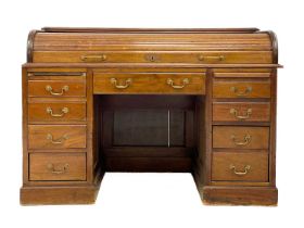 An Edwardian mahogany roll top desk.