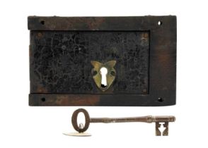A Victorian lock and key on oak.