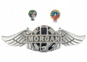 A cast metal winged 'Morgan' sign.