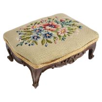 A small 19th century carved walnut woolwork footstool.