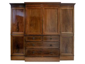 An Edwardian mahogany inlaid breakfront wardrobe.