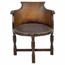 A Victorian walnut and leather elbow chair.