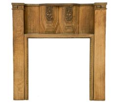 An Art Deco French walnut carved fire surround.