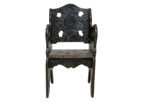 A Japanese Arts and Crafts floral carved armchair.