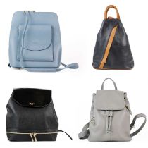 A collection of four backpack/handbags