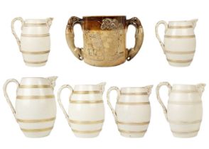 A set of six 19th century English porcelain barrel mask jugs.