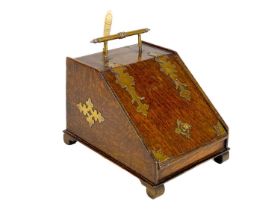 An early 20th century brass bound oak novelty tea caddy.