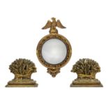 A 20th century Regency style miniature giltwood mirror with convex mirror plate and eagle cresting.