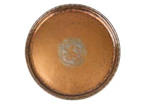 An Arts and Crafts copper charger by Hugh Wallis.