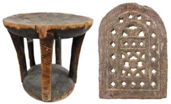 A carved and pierced stone screen & an African stool. The property of Peter Hone.