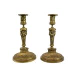 A pair of 19th century gilt metal neo classical candleholders.