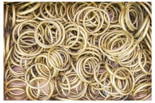 A large quantity of hollow brass curtain rings.