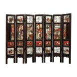 A Chinese alabaster and hardwood seven paneled screen, Qing Dynasty, late 19th century.