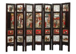 A Chinese alabaster and hardwood seven paneled screen, Qing Dynasty, late 19th century.
