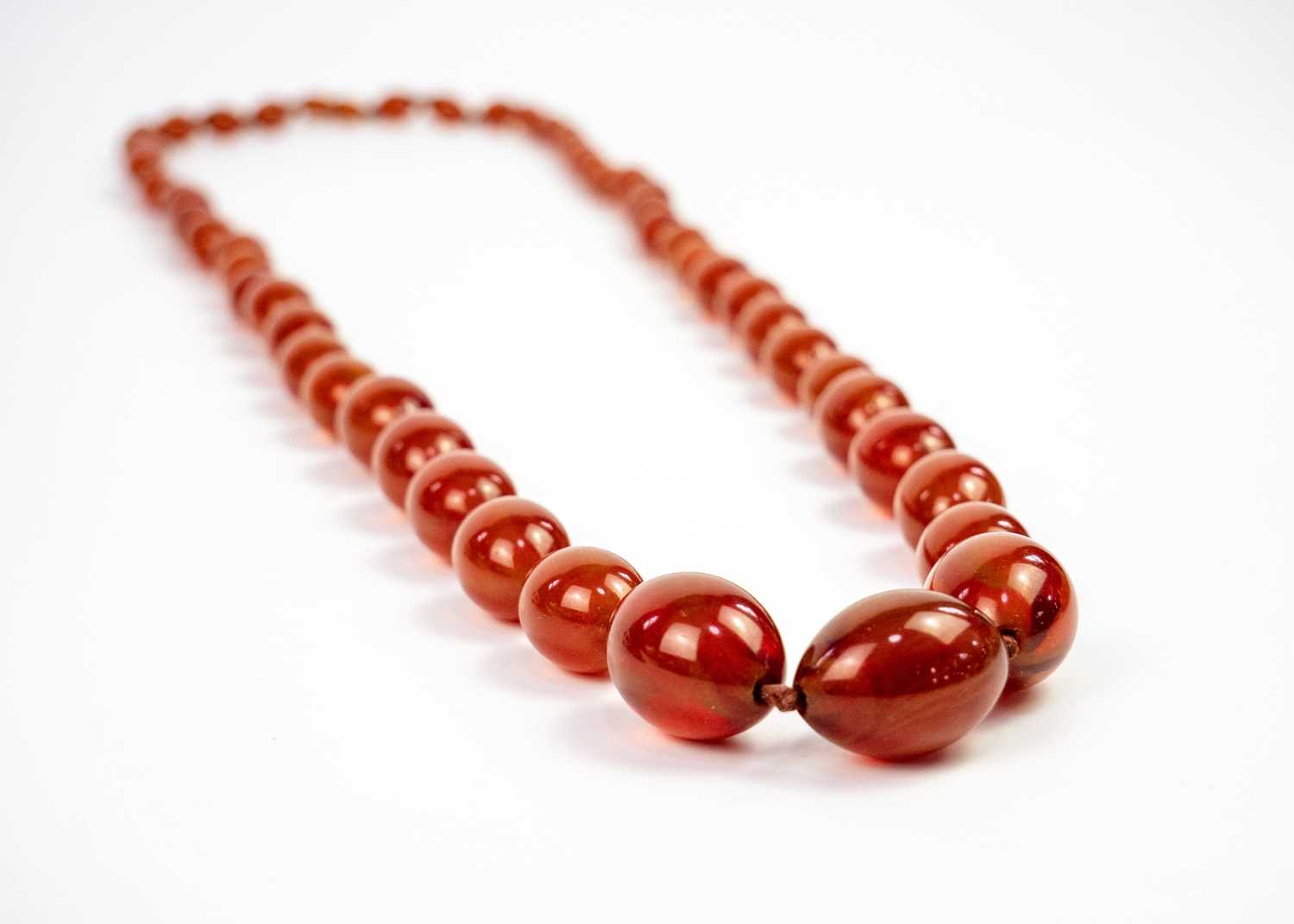 An amber style graduated oval bead necklace. - Image 2 of 3