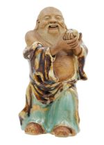 A Chinese pottery and flambe glazed model of Buddha, 19th century.