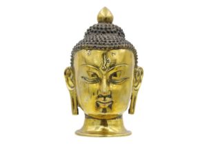 A Sino-Tibetan gilt bronze head of a Buddha, 19th century.
