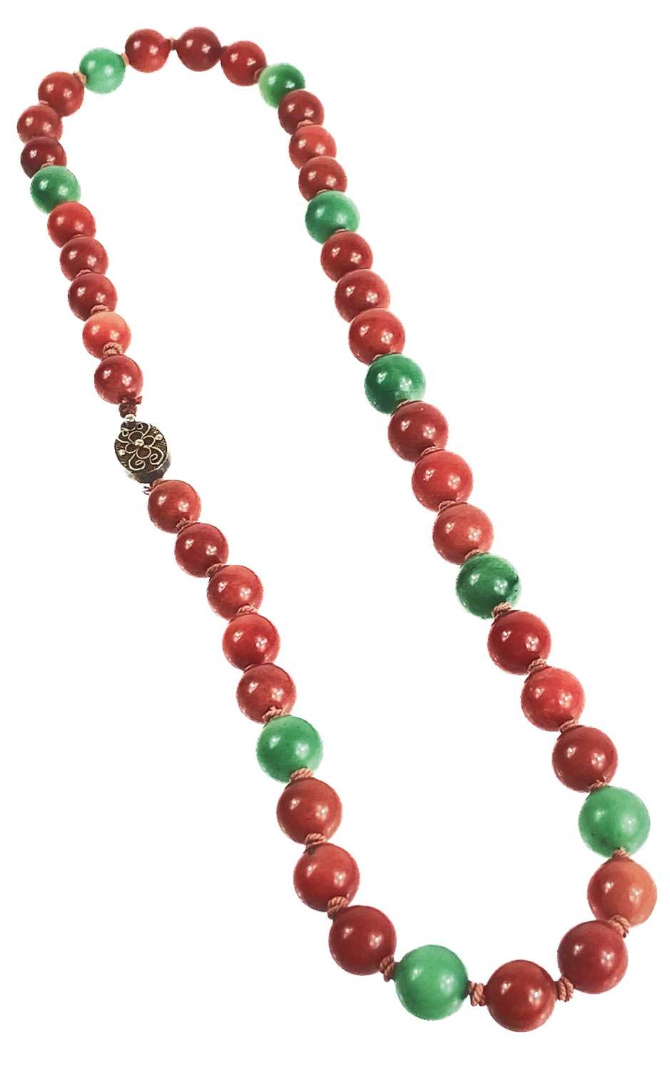 A Chinese green and russet jade bead necklace with silver filigree clasp. - Image 2 of 11