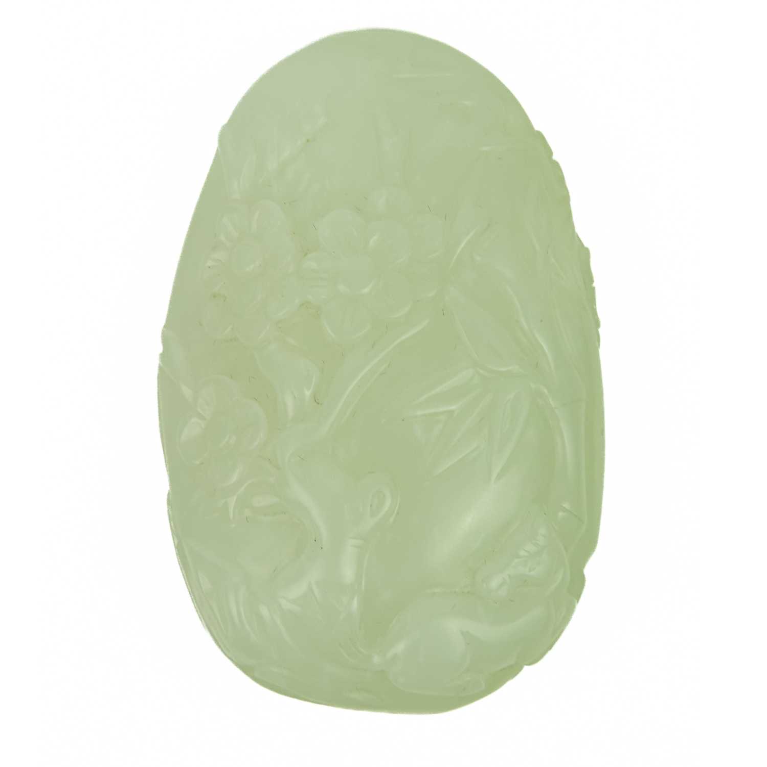 A Chinese pale celadon carved boulder.