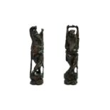 A pair of Chinese inlaid hardwood figures of immortals, late 19th century.