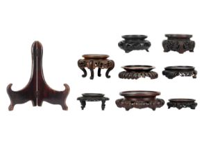 Eight Chinese carved wood vase stands.