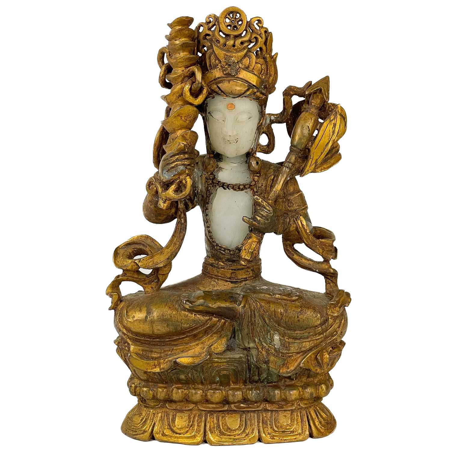 A Chinese white and gilded jade seated Buddha, 18th/19th century.