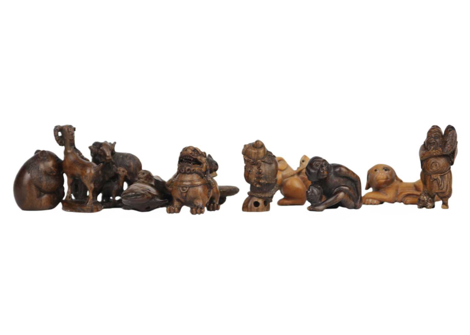 A collection of eleven Japanese carved wood netsukes, 20th century. - Image 5 of 5