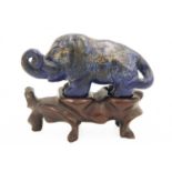 A Chinese lapis lazuli model of an elephant on stand, Qing Dynasty, 19th century.