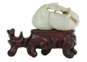 A Chinese carved jade goose turned to grasp lotus, Qing Dynasty, 19th century.