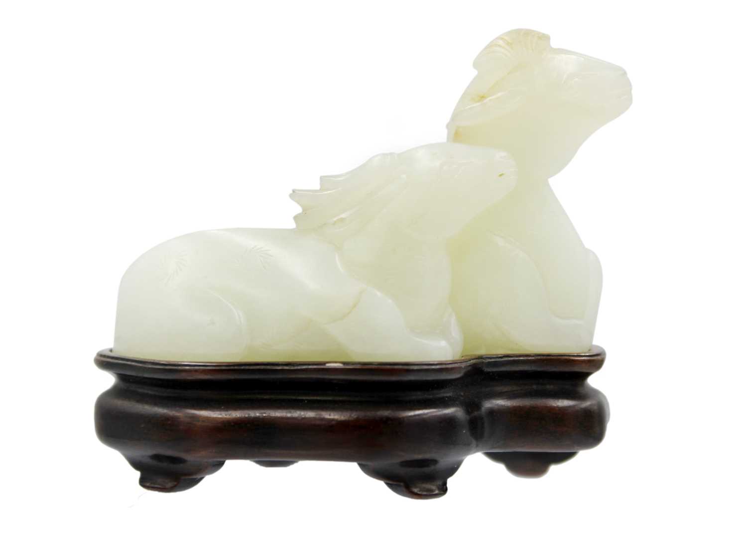 A Chinese carved celadon jade group of deers, Qing Dynasty, 19th century.