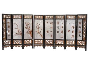 A Chinese carved wood eight paneled screen, early 20th century.