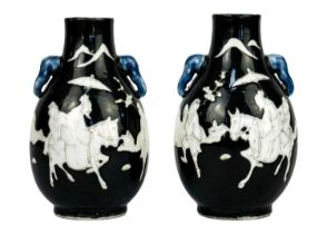 A pair of Chinese noire twin-handled ovoid vases, circa 1900.