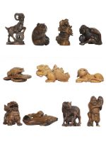 A collection of eleven Japanese carved wood netsukes, 20th century.