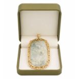 A carved jade and 9ct mounted pendant.