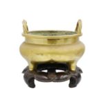 A large Chinese bronze twin-handled tripod censer on stand, Qing Dynasty.