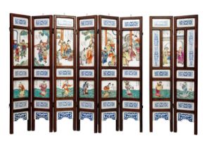 A Chinese porcelain and hardwood eight paneled screen, Qing Dynasty, early 20th century.