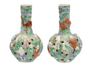 A pair of Chinese famille verte reticulated bottle vases, Qing Dynasty, 19th century.