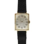 LONGINES - A 14ct rectangular cased lady's manual wind wristwatch with diamond set dial.