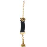 A Victorian high purity gold (tests 18ct) seal fob on a gold-mounted black ribbon.