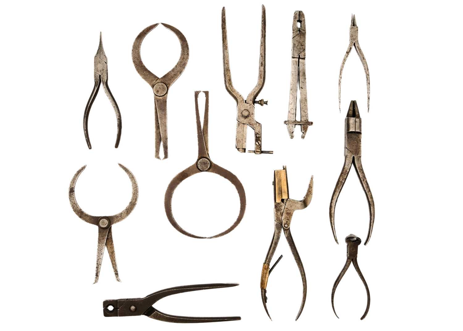 A selection of watchmakers calipers, clamps, dividers and pliers.
