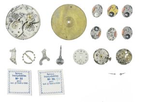A collection of watch makers parts, spares and movements.
