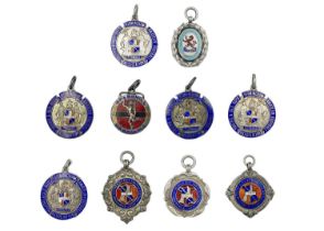 A collection of ten silver and enamel football fobs.