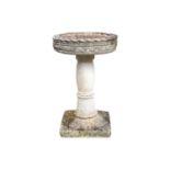 A reconstituted stone bird bath of circular form, on square base.