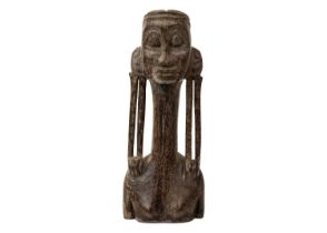 An Oceania wood carved figure with an elongated neck and lobe gauged ears.