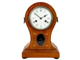 An Edwardian mahogany and inlaid balloon-shaped mantel clock.