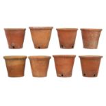 Eight hand thrown terracotta plant pots.