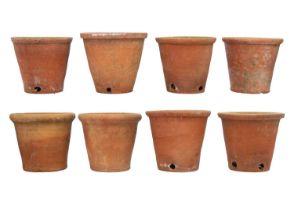 Eight hand thrown terracotta plant pots.